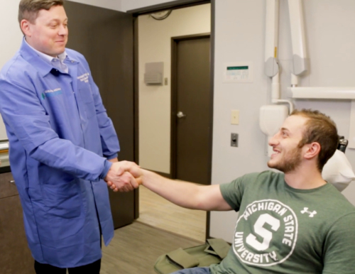 Dr Kittle shakes a patient | greater michigan oral surgeons implant center's Hand