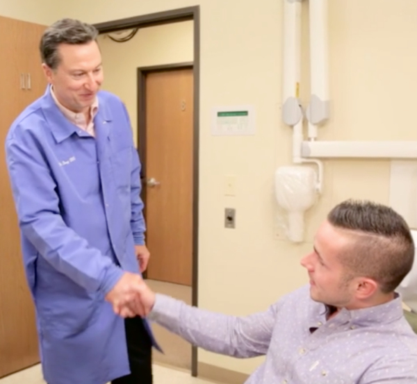 Dr Frey shakes a patient | greater michigan oral surgeons implant center's Hand