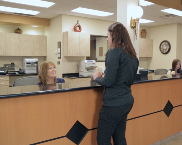 First visit a patient talks to our front desk specialists | greater michigan oral surgeons implant center